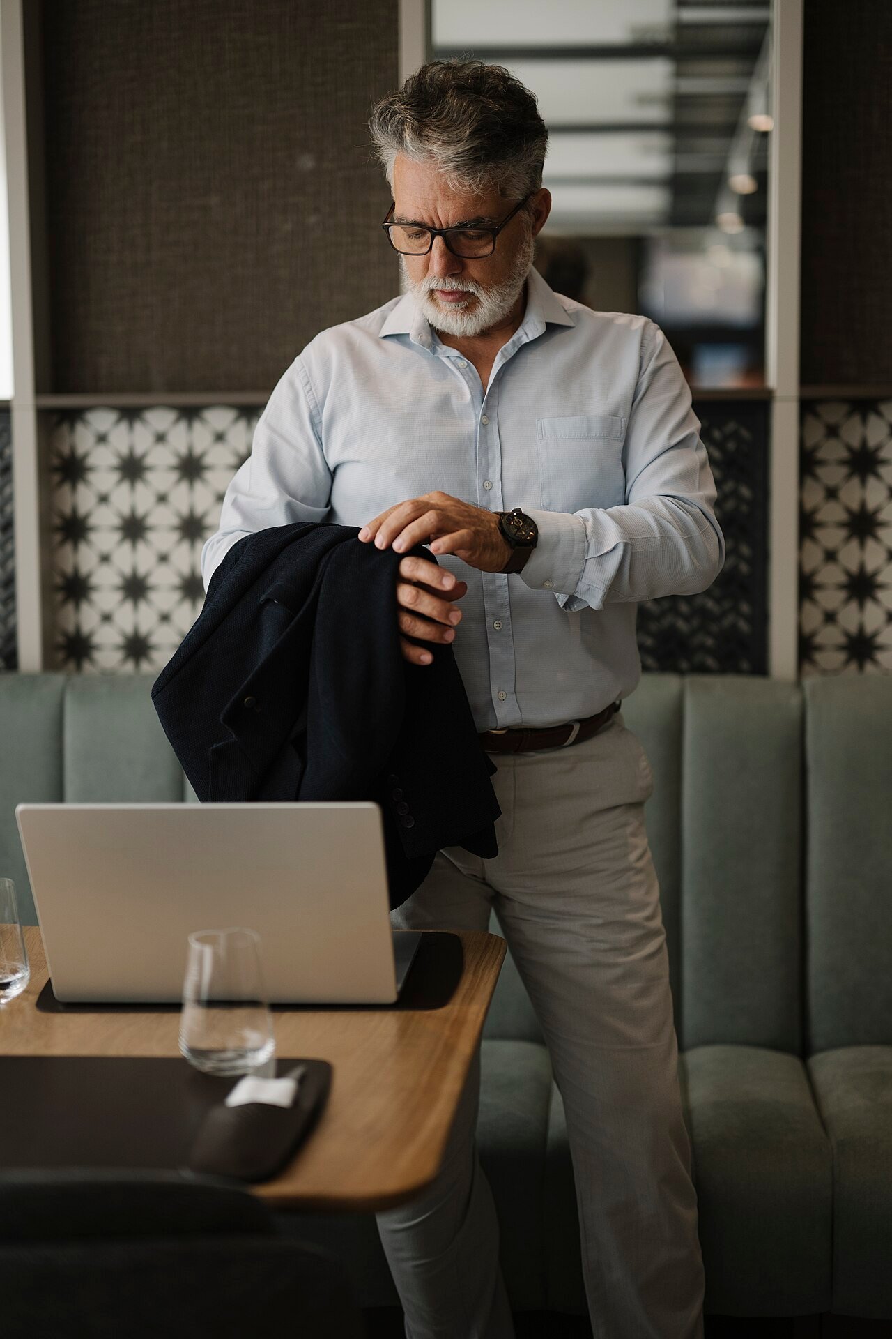 Business professional preparing for a meeting with a laptop and documents